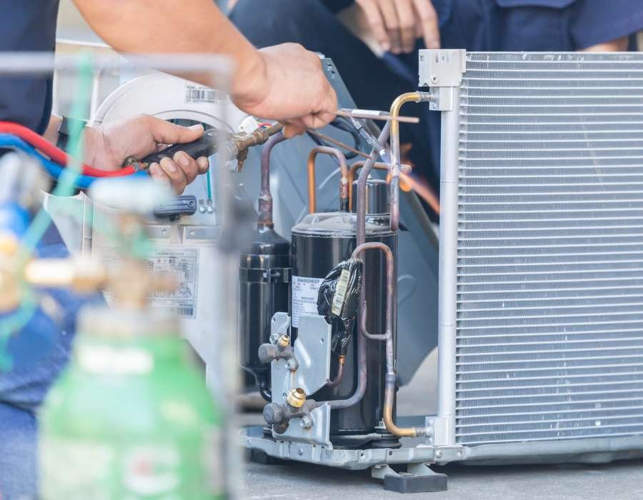 Close-up of refrigerant service on an HVAC condenser